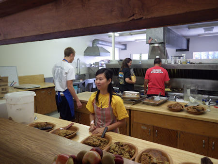 Photo looking into the kitchen with staff working.